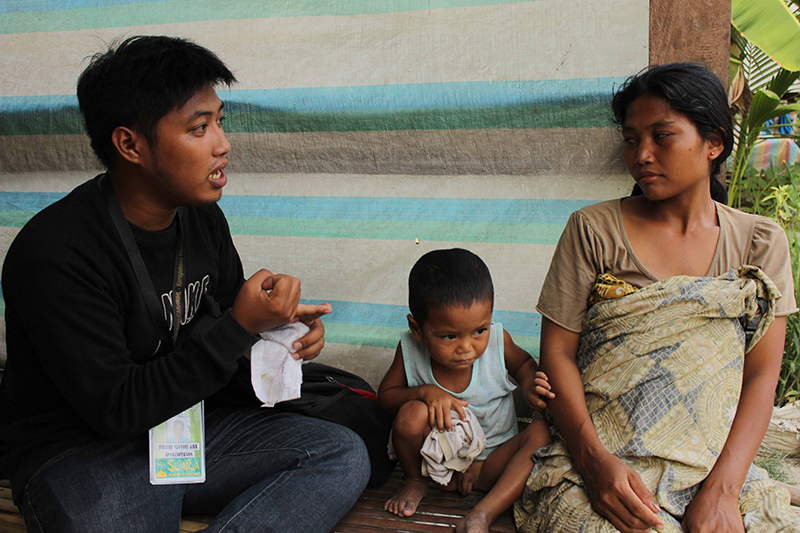 Jerome Aba (left) interviews one of the civilians affected by the AFP attacks.