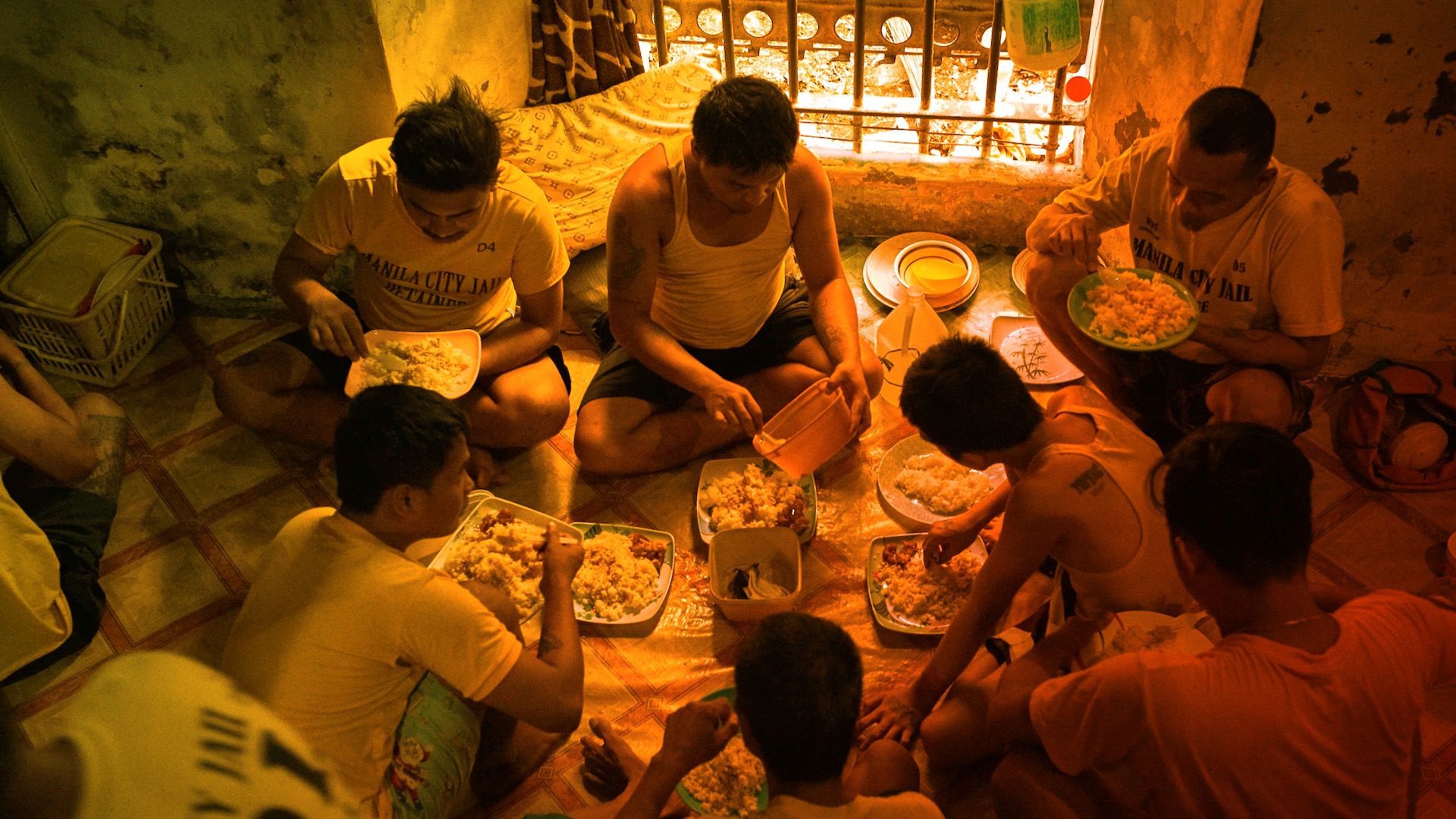 A group of inmates at Manila City jail sharing a meal